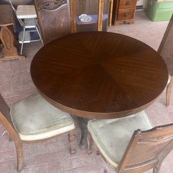 Round table with three add a leafs and 4 chairs