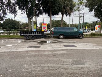 Green Ford Passenger Van with Utility Trailer