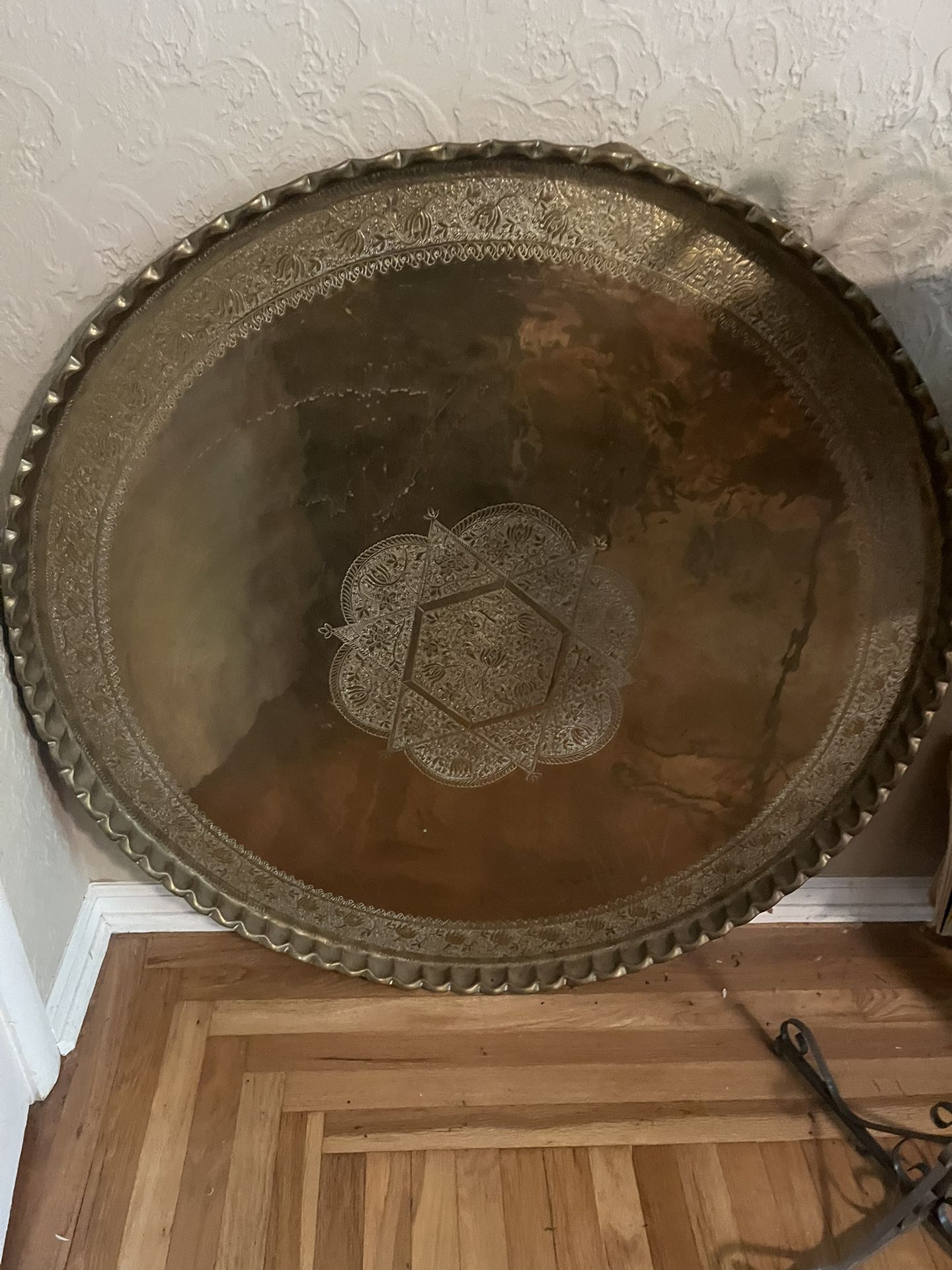 A plate a big silver round plate from India. It's 4 1/2 feet tall all the way around it's brass it's from the late 50s.