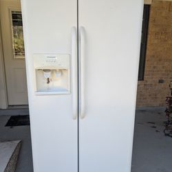 Whirlpool dishwasher, and white Frigidaire side-by-side refrigerator