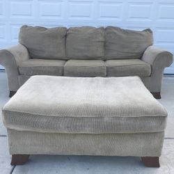 Beige sleeper couch and ottoman set