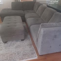 Taupe and black sectional couch  with storage ottoman 