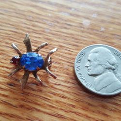 Gold pin with a sapphire