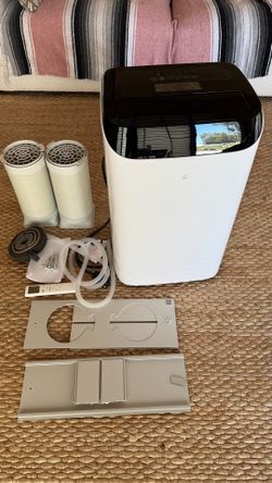 Portable air conditioner with a window attachment, rated at 12,000 BTU