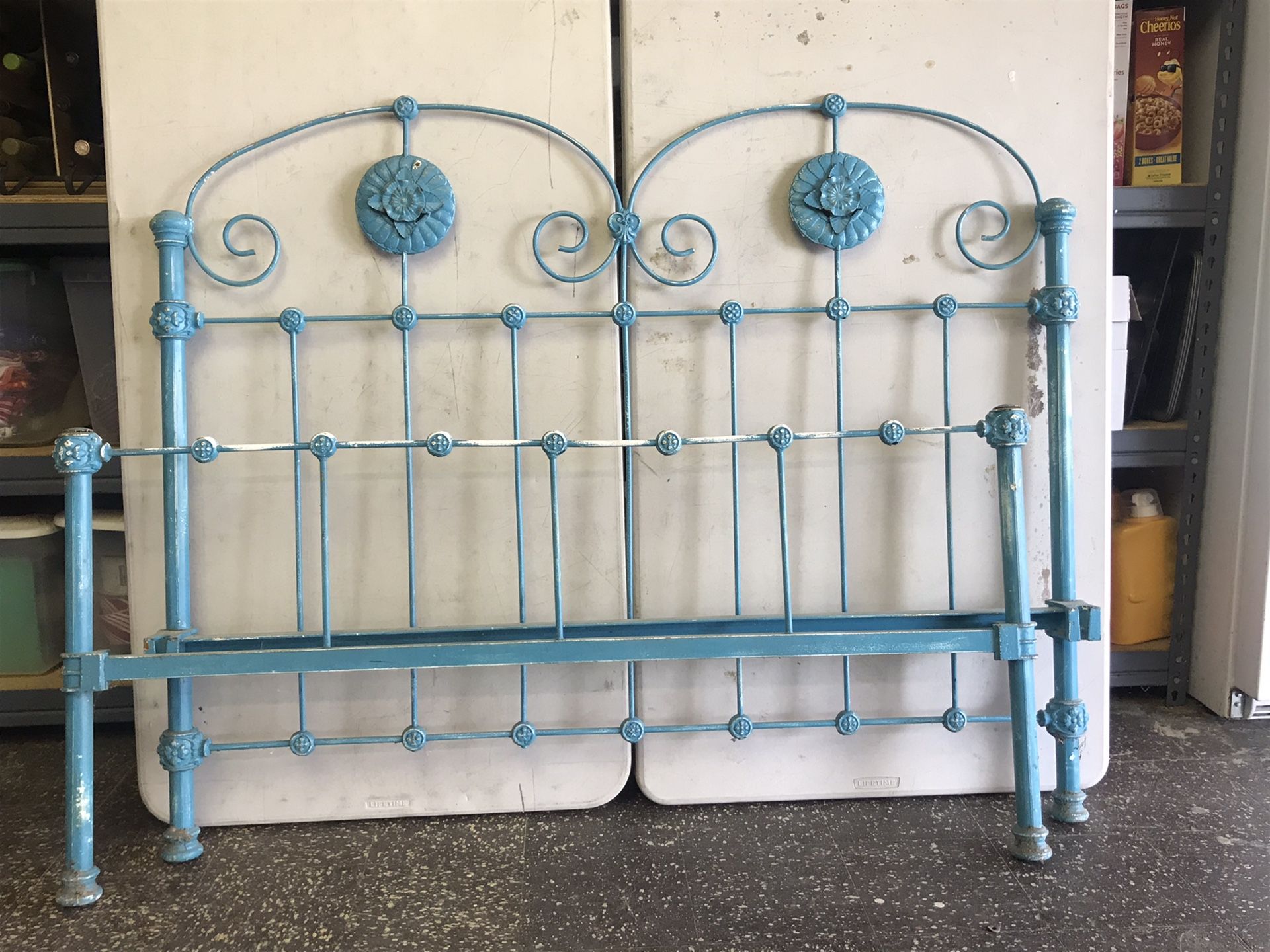 old iron bed frame with rails