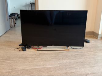 Sony 50 inch TV with soundbar and subwoofer