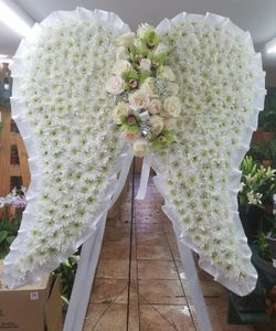 Funeral arrangements any color made with fresh flowers.