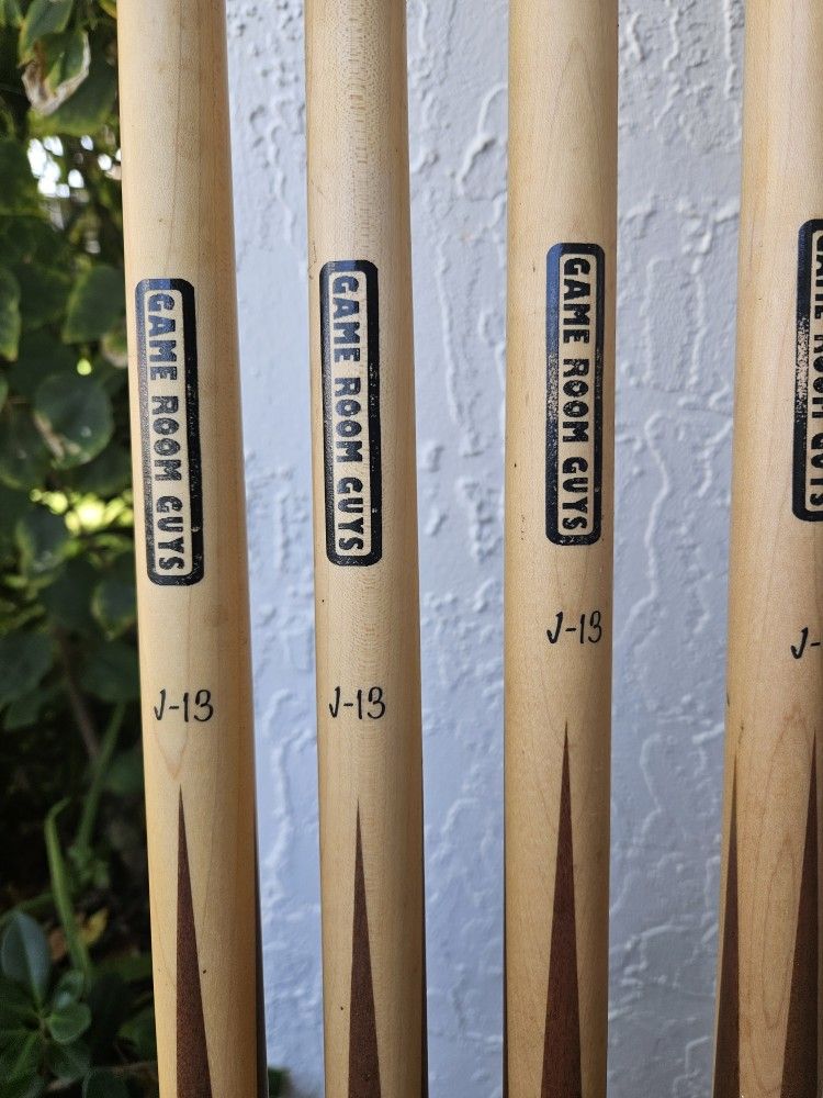 4 "Game Room Guys J-13" cues in very good, functional condition. Plus 2 Additional Assorted cues.