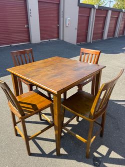 Square wooden high table and six chairs