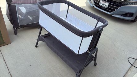 Baby beside bassinet