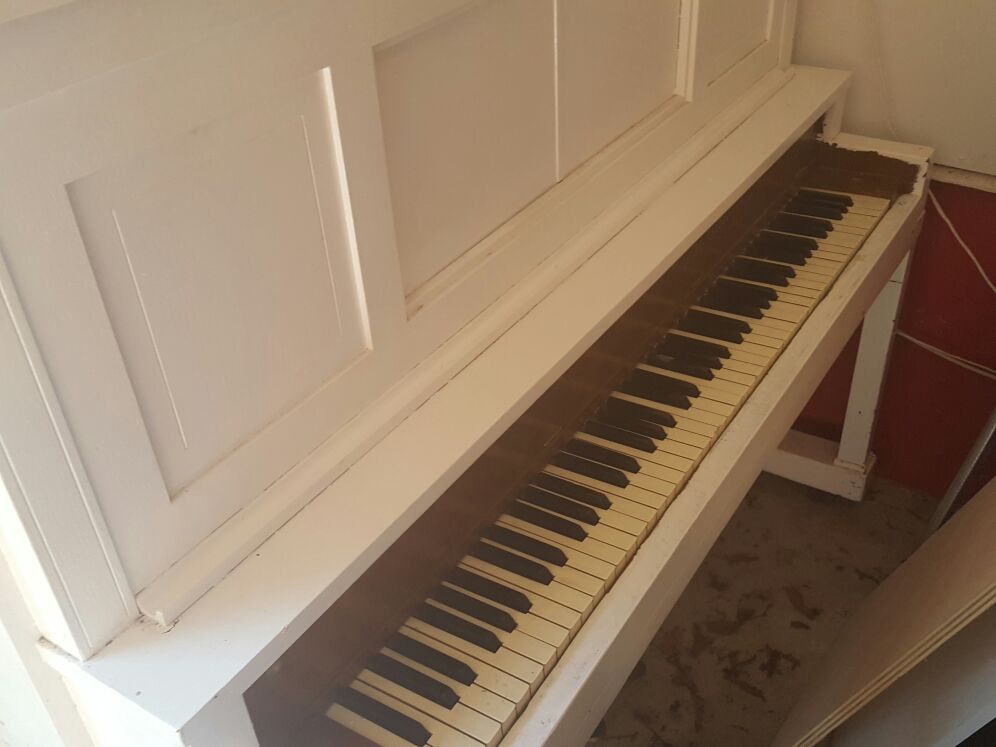Antique white piano. Over 50 years