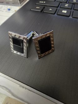 Black and silver colored cufflinks