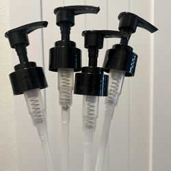 Set of four black pump dispensers