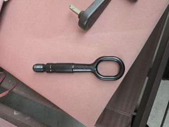 This is a genuine VW/Audi front towing eye hook, part number 8K0805615A. 
It is used for safely attaching a tow strap to a vehicle in case of a breakd