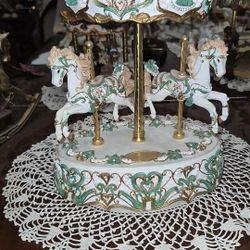 This is a San Francisco Music Box Company Classic Horse Musical Carousel. 