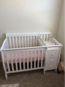 White crib with changing table attached