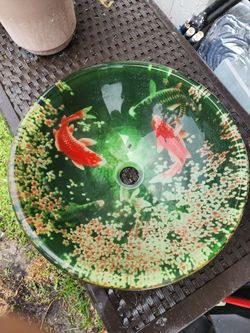 Vessel sink with koi deign