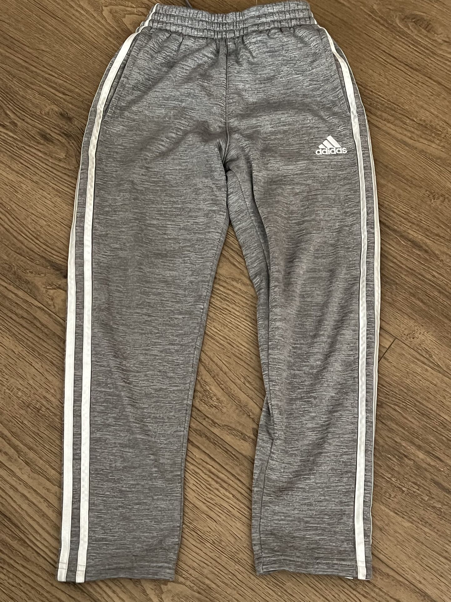 Adidas Kids Gray Joggers with White Stripes Size 8. Stylish gray joggers for kids. Features iconic white stripes. Perfect for active wear. Back bottom