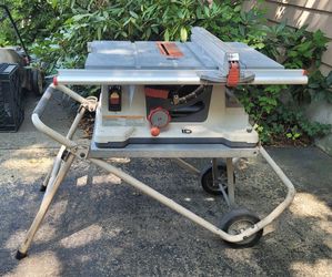 Portable RIDGID 10-inch Table Saw mounted on a rolling work stand. This is a heavy-duty, corded electric power saw designed for jobsite