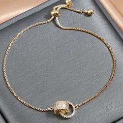 Elegant Adjustable Ladies Bracelet With Interlocking Ring Pendant, Cubic Zirconia Inlay, Golden Jewelry For Vacation & Everyday Wear  $10