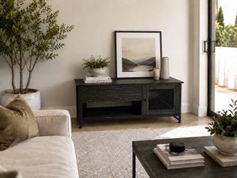 Black coffee table with lift top, shelf, and cabinet