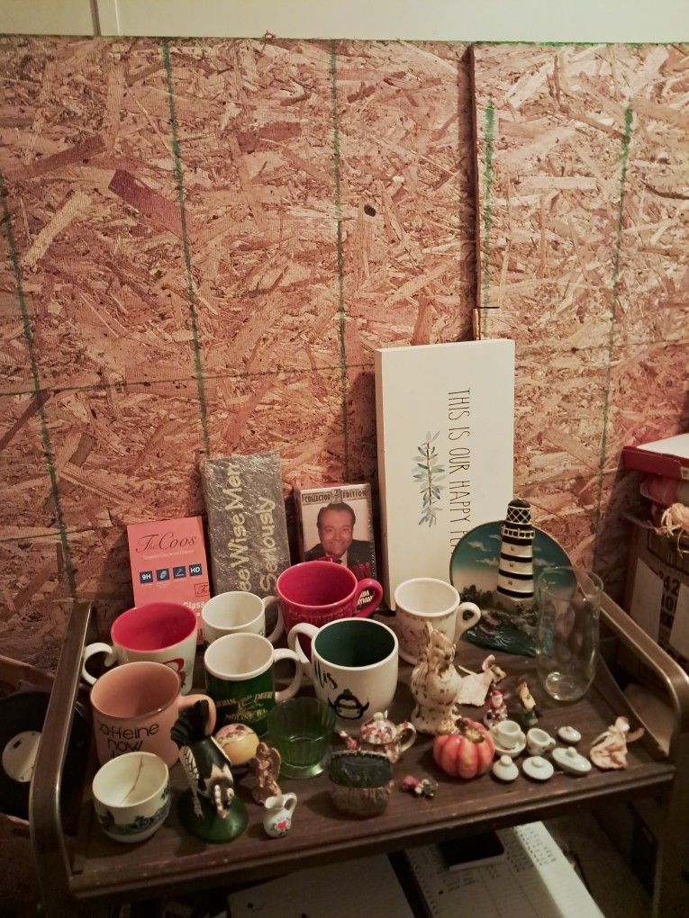 Box Lot Of Thirty Three Assorted Items Coffee Mugs Cups Light House Statue Roosters Pictures Vhs Tapes Small Miniature Ceramic Glass Items 