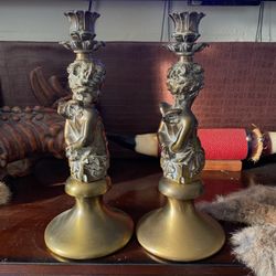 bronze cherub candlestick holder, possibly antique, reflecting a neo-classical design