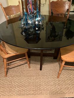 Round glass table with four chairs