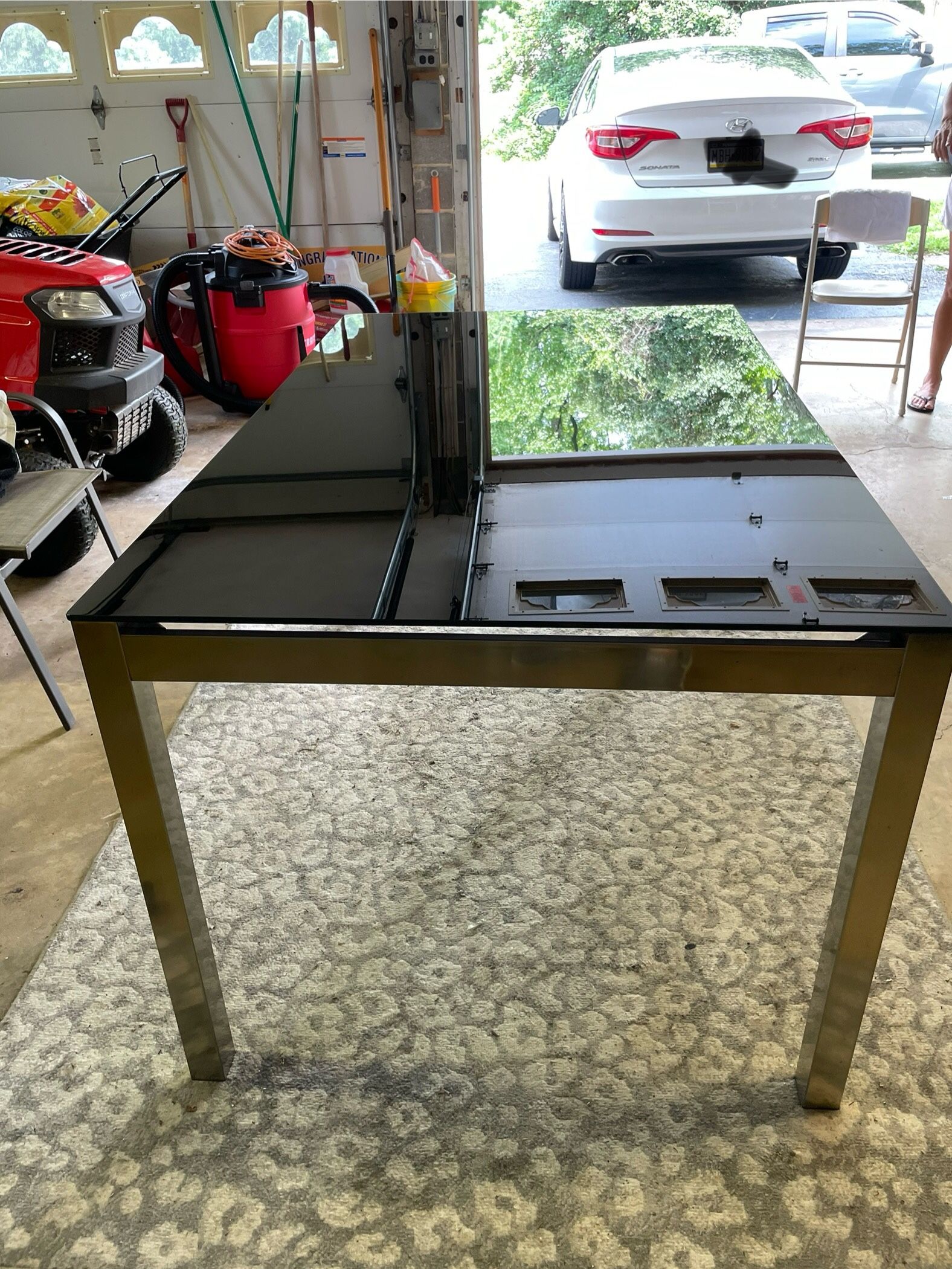 Black Glass Top Table with steel legs from Ashley furniture 5ft L x 3ft W x 30” H (no chairs include