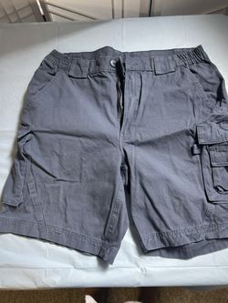 Blue cargo shorts with adjustable waist and pockets. Size: 36" 