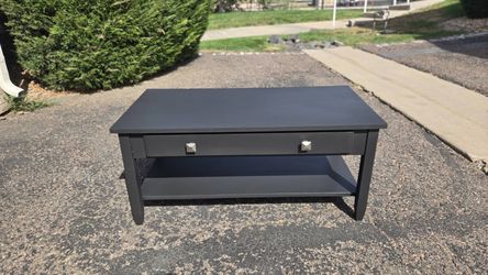 Flat black coffee table with drawer storage