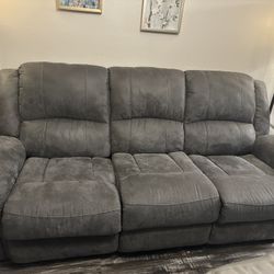 Grey couch with reclining sides