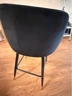 Black velvet swivel island bar stools with gold leg accents