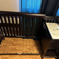 Crib with connected changing table.