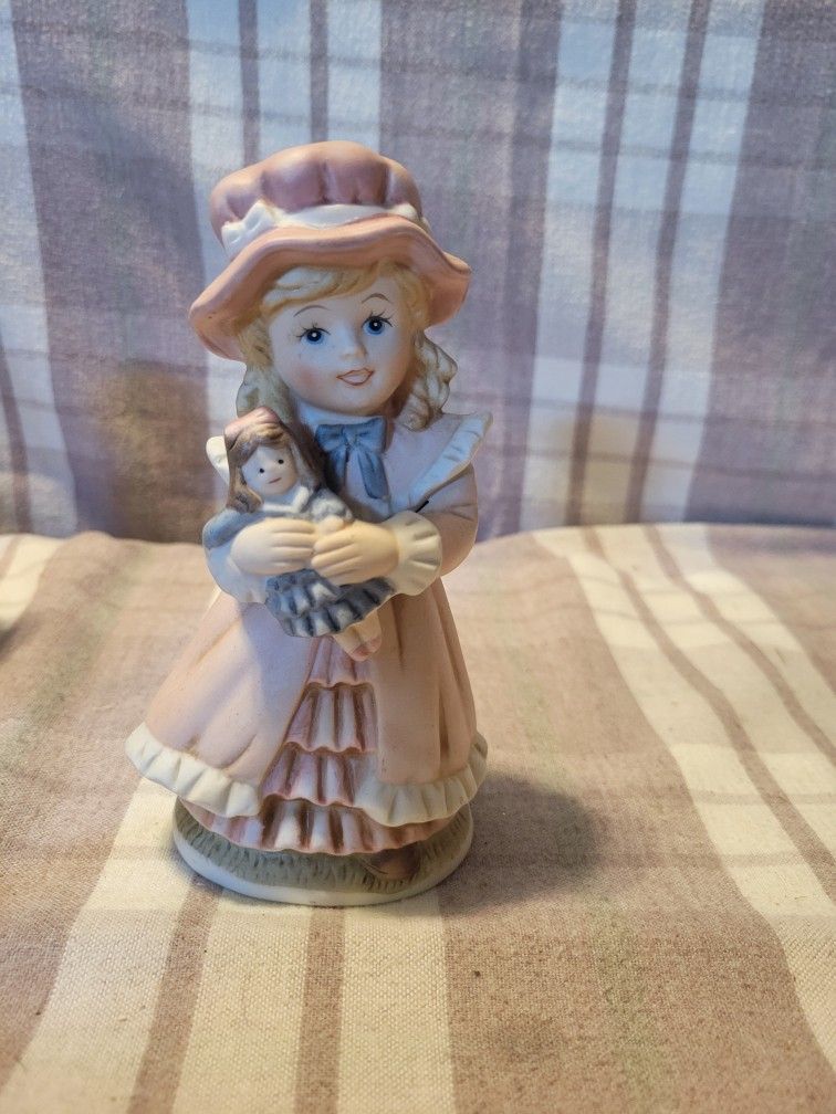 Girl Holding Doll Figurine