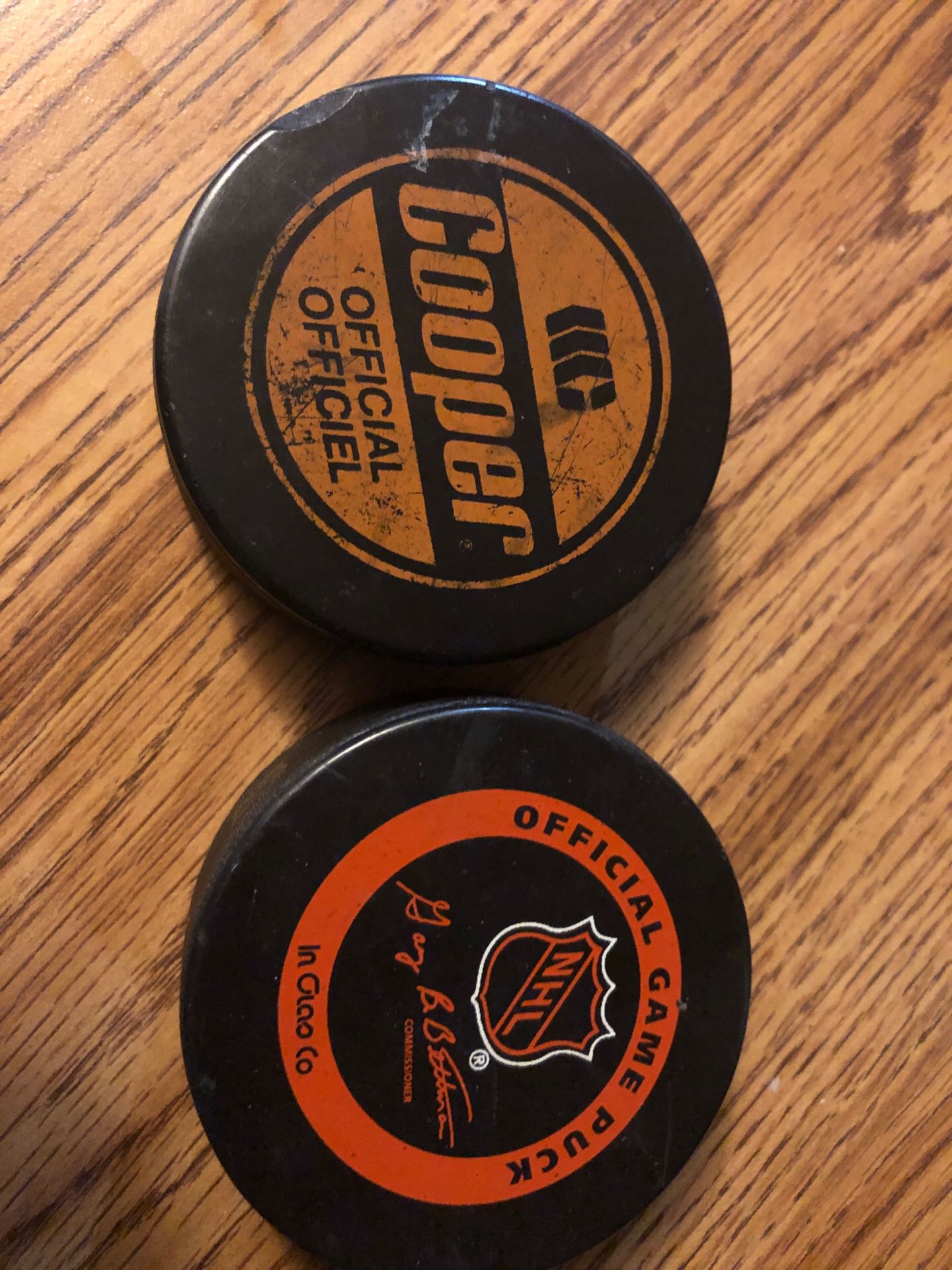 Two real hockey pucks used for game