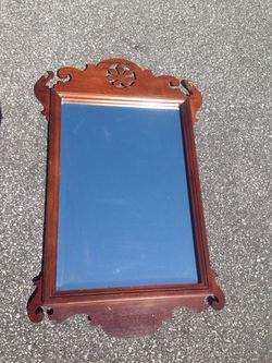 Antique wall mirror with beveled edges and decorative trim