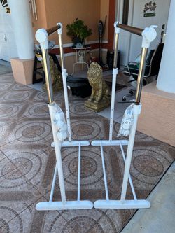 Two garment racks in different sizes, featuring wheels for mobility; they measure 34 inches in width.