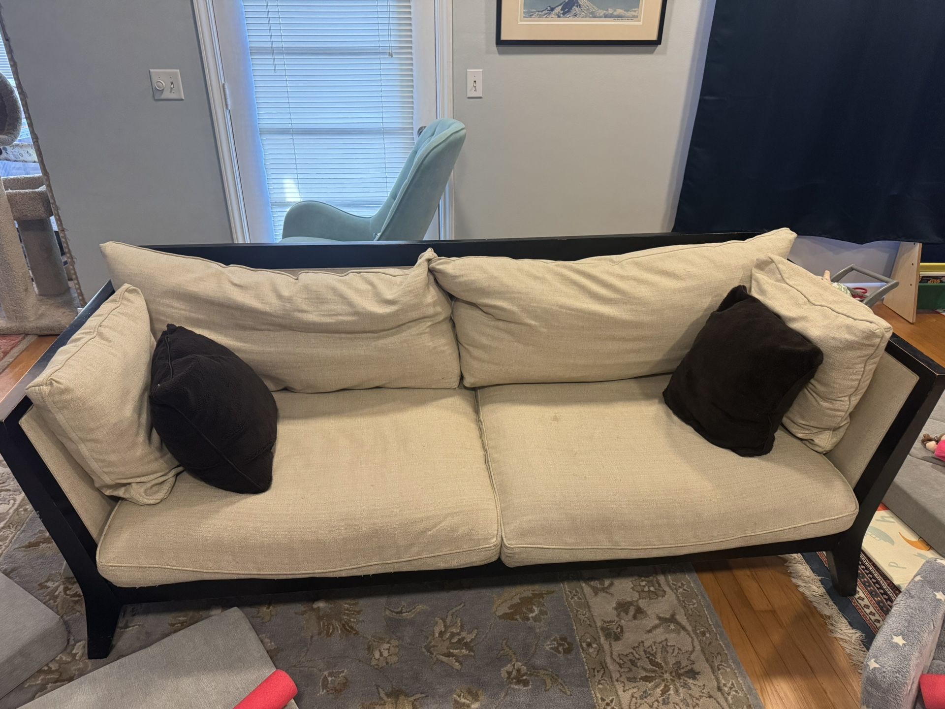 Dania couch. Black wood frame cream cushions