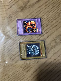 Two YU GI OH cards. Blue Eyes White Dragon SDK-001