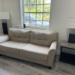 Beige Couch With 2 Tables And Lamp