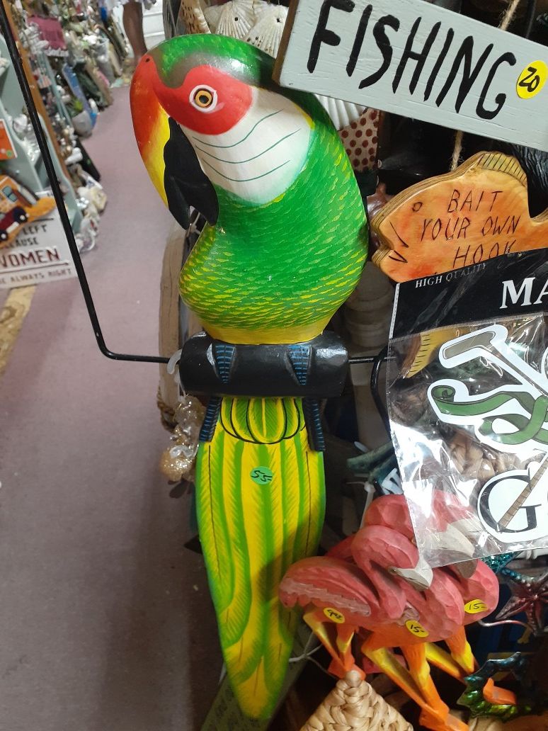 Large colorful wooden parrot on swing