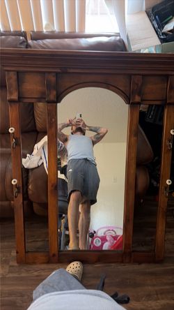 Vintage brown wooden mirror with original hooks