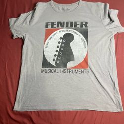 This is a Lucky Brand T-shirt in size L, designed with a Fender Decal. The color of the T-shirt is gray, made for men's wear. 