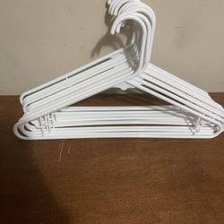 12 white plastic hangers 