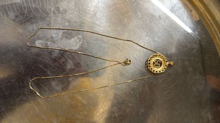 Price is firm 14 K solid GOLD chain with the pendant tell the weight is 7.47 g
