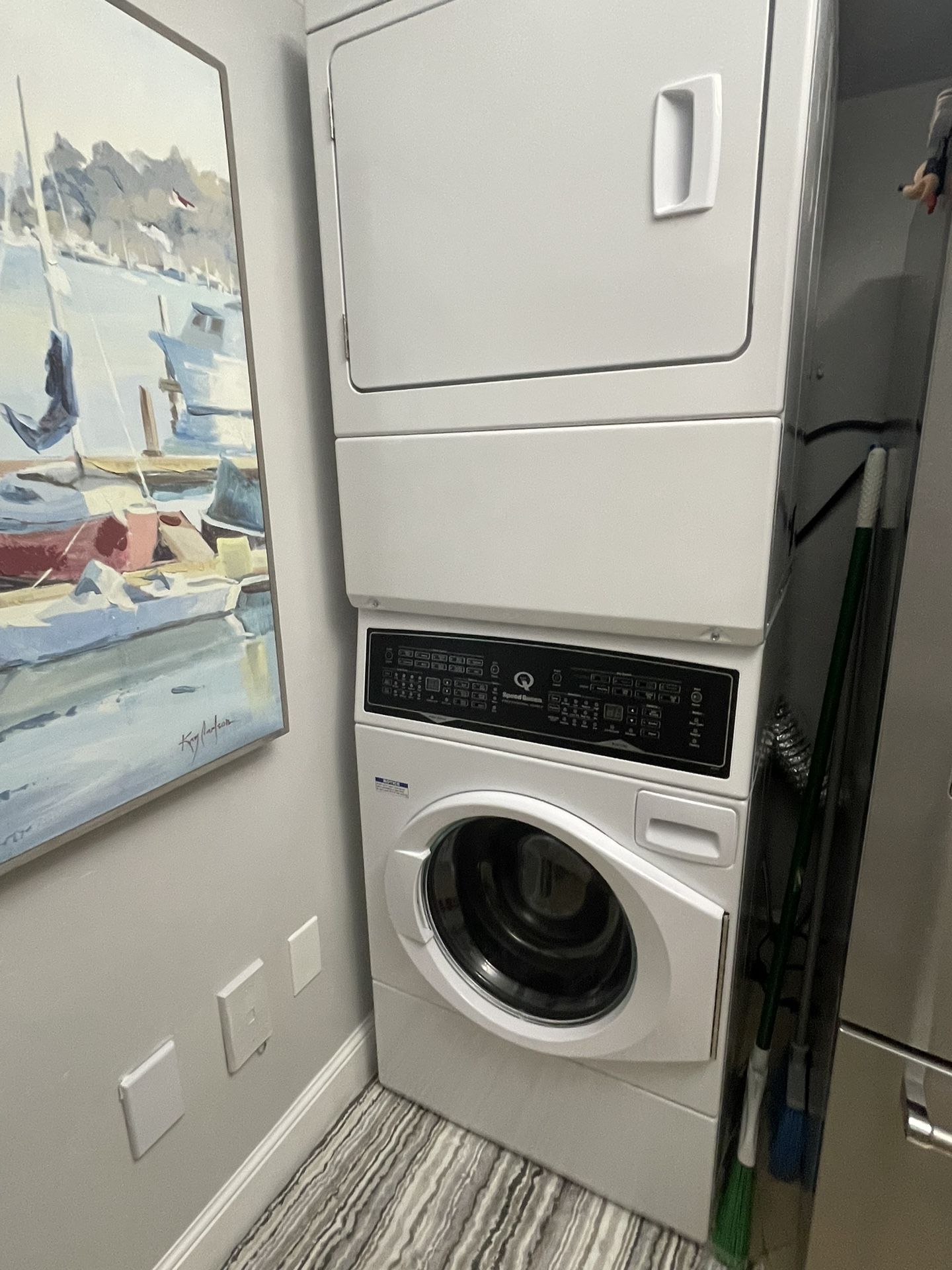 This Speed Queen SF7003WE stacked washer and dryer set features a white color and a compact 27-inch width, making it perfect for small spaces. The ele
