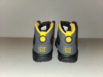 Nike Air Jordan 9 Retro "Dark Charcoal University Gold" sneakers.  