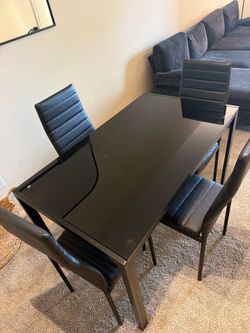 Small black glass dining table and 4 chairs