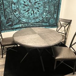 round grey table with 3 chairs